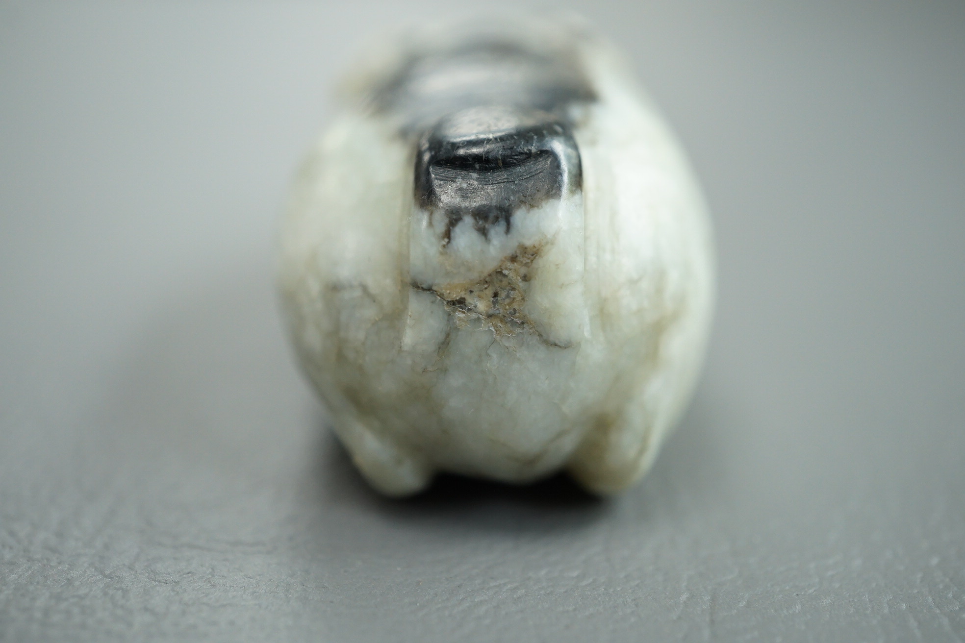 A Chinese white and black jade figure of a recumbent tiger, Song dynasty